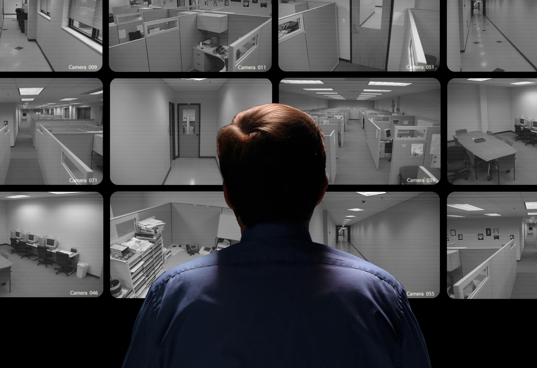 Security officer monitoring CCTV surveillance screens
